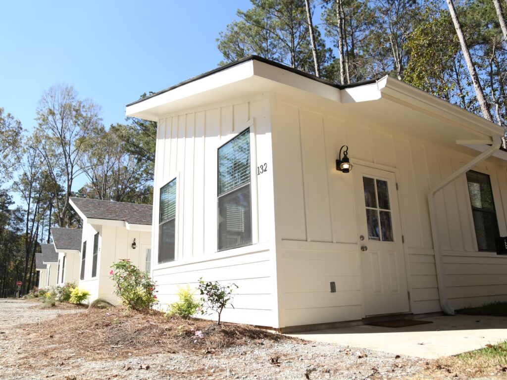 A modern rental cabin with a covered porch at Fireside RV Resort in Ponchatoula, Louisiana.