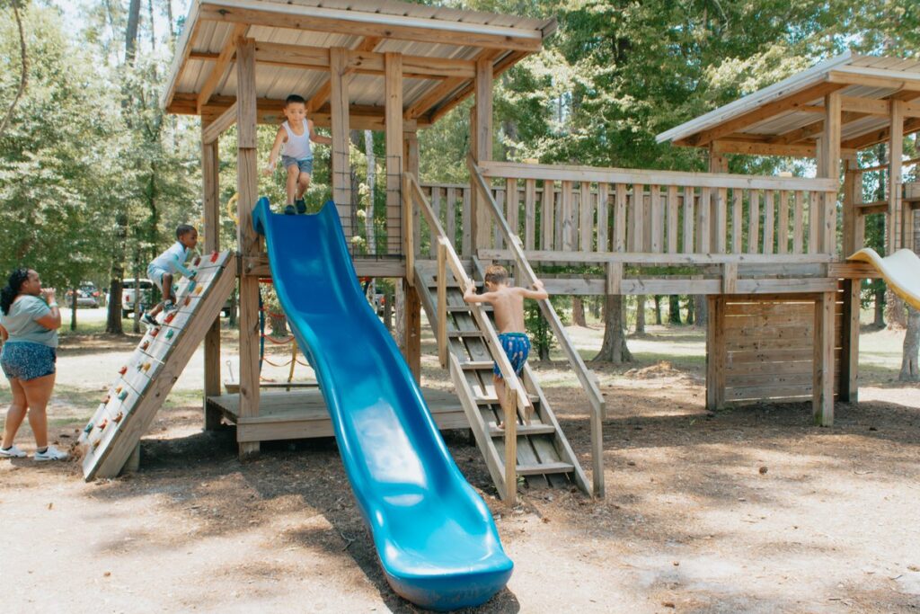 Children playing on the wooden playground at Fireside RV Resort in Ponchatoula, Louisiana.
